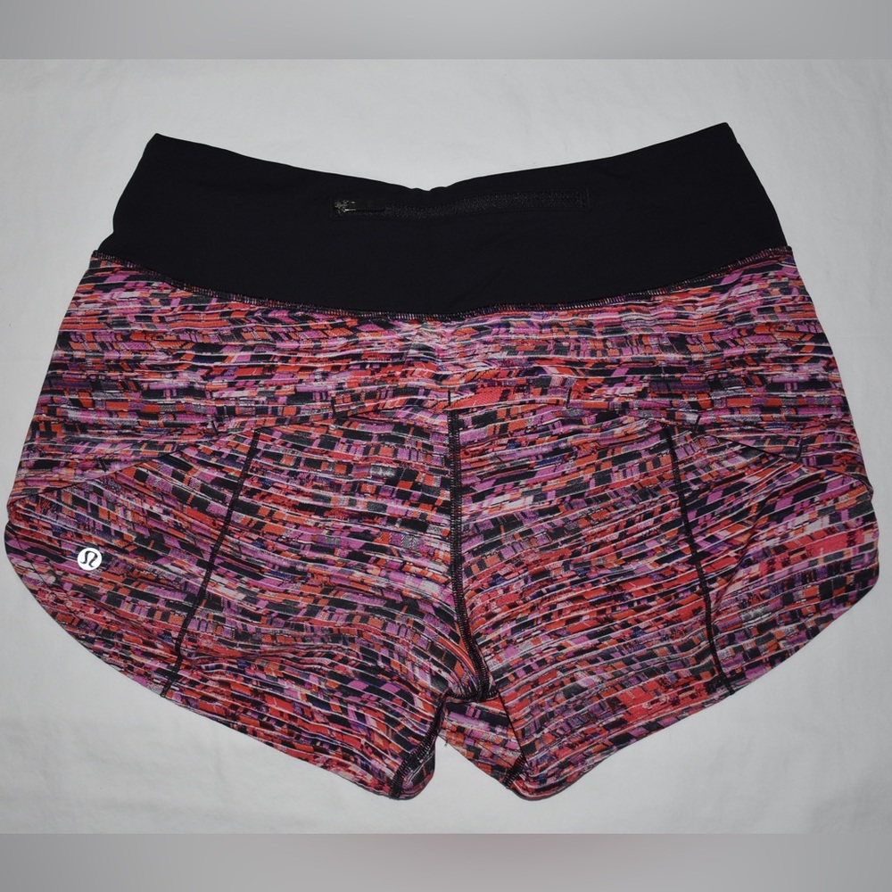 Size 4 Lululemon speed up shorts in a pink/orange pattern.